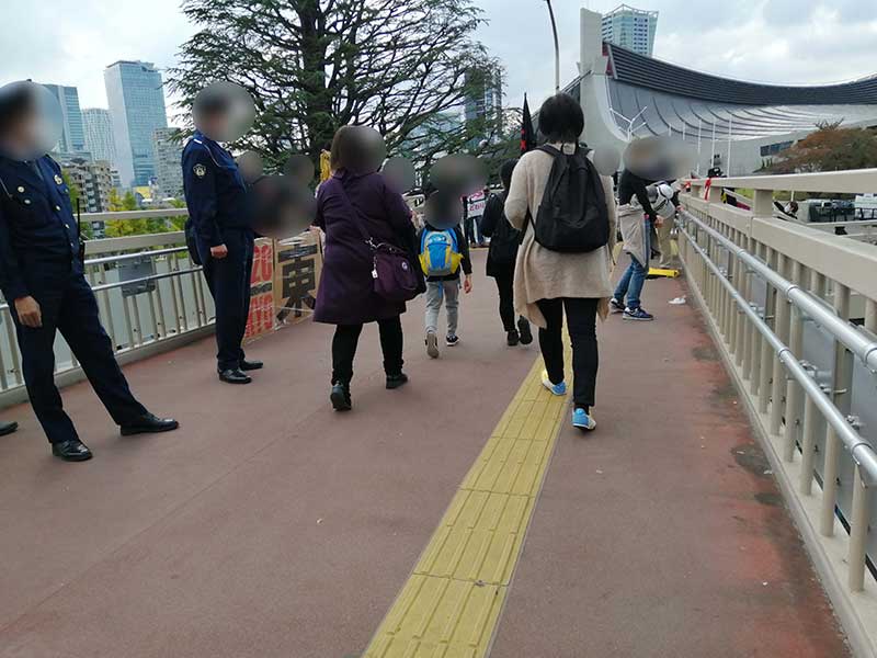 歩道橋で開催反対の人たちがアピール